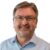 Verein Wiga Digital Dieter Hofer: Porträt eines freundlich lächelnden Mannes mit Brille und hellem Hemd vor schwarzem Hintergrund. Das Bild zeigt Dieter Hofer als erfahrenen Mentor und Digitalisierungsexperten mit sympathischer und professioneller Ausstrahlung.